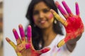 Portrait of a beautiful girl full of colored powder all over the body. Young girl plays with colors on the occasion of Holi. Royalty Free Stock Photo