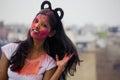 Portrait of a beautiful girl full of colored powder all over the body. Young girl plays with colors on the occasion of Holi. Royalty Free Stock Photo