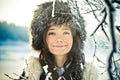 Portrait of a beautiful girl in a fur hat in backl