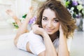 Portrait of a beautiful girl gentle, cute young, lying on the floor, with laptop posing Royalty Free Stock Photo