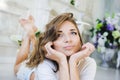 Portrait of a beautiful girl gentle, cute young, lying on the floor, with laptop posing Royalty Free Stock Photo