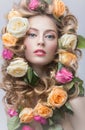 Portrait of a beautiful girl with a gentle pink make-up and lots of flowers in her hair. Beauty face. Royalty Free Stock Photo