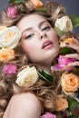 Portrait of a beautiful girl with a gentle pink make-up and lots of flowers in her hair. Beauty face. Royalty Free Stock Photo