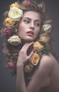 Portrait of a beautiful girl with a gentle pink make-up and lots of flowers in her hair. Spring image. Beauty face.