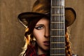 Portrait of a beautiful girl with a guitar in country-style Royalty Free Stock Photo