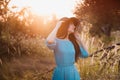 Portrait of a beautiful girl in a hat in a field in sunset light Royalty Free Stock Photo