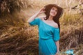 Portrait of a beautiful girl in a hat in a field in sunset light Royalty Free Stock Photo