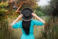 Portrait of a beautiful girl in a hat in a field in sunset light Royalty Free Stock Photo