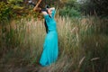 Portrait of a beautiful girl in a hat in a field in sunset light Royalty Free Stock Photo