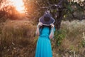 Portrait of a beautiful girl in a hat in a field in sunset light Royalty Free Stock Photo