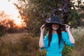 Portrait of a beautiful girl in a hat in a field in sunset light Royalty Free Stock Photo