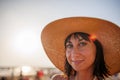 Portrait of a beautiful girl in a hat. young woman smiling on the beach - Charming girl enjoying a sunny day - Healthy lifestyle Royalty Free Stock Photo