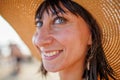 Portrait of a beautiful girl in a hat. young woman smiling on the beach - Charming girl enjoying a sunny day - Healthy lifestyle Royalty Free Stock Photo