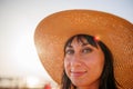 Portrait of a beautiful girl in a hat. young woman smiling on the beach - Charming girl enjoying a sunny day - Healthy lifestyle Royalty Free Stock Photo