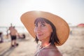 Portrait of a beautiful girl in a hat. young woman smiling on the beach - Charming girl enjoying a sunny day - Healthy lifestyle Royalty Free Stock Photo