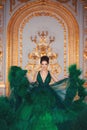 Portrait of a beautiful girl in a Haute couture green dress.