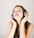 Portrait of beautiful girl in headphones, listening music, singing a song on white, lifestyle people concept Royalty Free Stock Photo
