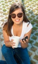 Portrait of beautiful girl holding coffee cup outside