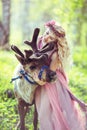 Portrait of Beautiful girl hugging a reindeer