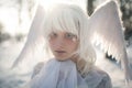 Portrait of beautiful girl in image of good angel with wings