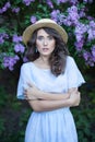 Portrait of a beautiful girl in a lilac garden. A woman walks in a flowered park. Summer holiday in the garden. Outdoor fashion ph Royalty Free Stock Photo