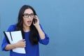 Portrait of a beautiful girl on the phone while getting shocking news Royalty Free Stock Photo