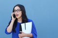 Portrait of a beautiful girl on the phone while getting shocking or surprising news Royalty Free Stock Photo