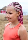 Portrait of beautiful girl with pink dreadlocks standing outdoor