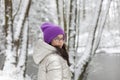 Portrait of a beautiful girl in a pink hat and glasses in the winter forest Royalty Free Stock Photo