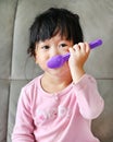Portrait of beautiful girl playing with spoon while eating Royalty Free Stock Photo