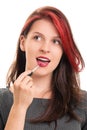 Portrait of a beautiful girl putting lipstick Royalty Free Stock Photo