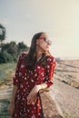 Portrait of a beautiful girl in a red dress and goggles on vacation