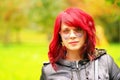 Portrait of a beautiful girl with red hair and heart like glassess