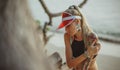 Portrait of a beautiful girl in a red visor closeup. Wearing Large turquoise earrings. Holiday in Thailand On the