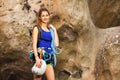 Girl standing with rock climbing equipment