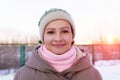 Portrait of beautiful girl at sunset in the winter. Smiling to camera, cheerful, true emotions. Winter fashion Royalty Free Stock Photo