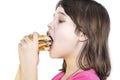 Portrait of a beautiful girl, teenager and schoolgirl, holding a hamburger on a white background Royalty Free Stock Photo