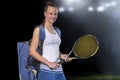 Portrait of beautiful girl tennis player with a racket on dark background Royalty Free Stock Photo