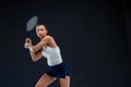 Portrait of beautiful girl tennis player with a racket on dark background Royalty Free Stock Photo