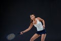 Portrait of beautiful girl tennis player with a racket on dark background Royalty Free Stock Photo