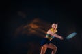 Portrait of beautiful girl tennis player with a racket on dark background Royalty Free Stock Photo