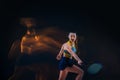 Portrait of beautiful girl tennis player with a racket on dark background Royalty Free Stock Photo