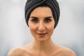 Portrait of a beautiful girl with a turban on her head. Pretty close-up face of a fashionable woman.