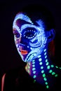 Girl with neon make-up in color light Royalty Free Stock Photo