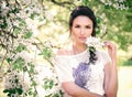 Portrait of a beautiful girl under a flowering tree. A young girl against the background of spring blooming apple trees. Royalty Free Stock Photo