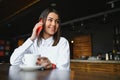 Portrait of beautiful girl using her mobile phone in cafe Royalty Free Stock Photo