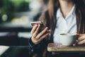 Portrait of beautiful girl using her mobile phone in cafe. Close up Royalty Free Stock Photo