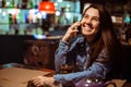 Portrait of beautiful girl using her mobile phone in cafe. Royalty Free Stock Photo