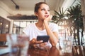 Portrait of beautiful girl using her mobile phone in cafe. Royalty Free Stock Photo