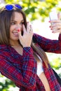 Portrait of beautiful girl using her mobile phone in city. Royalty Free Stock Photo